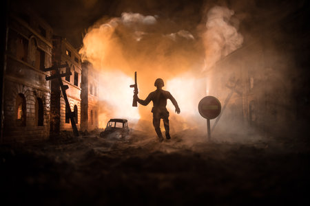 War Concept. Military silhouettes fighting scene on war fog sky background, World War Soldiers Silhouette Below Cloudy Skyline At night. Battle in ruined city. Selective focusの写真素材