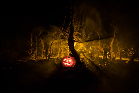Scary view of zombies at cemetery dead tree, moon, church and spooky cloudy sky with fog, Horror Halloween concept. Selective focusの写真素材
