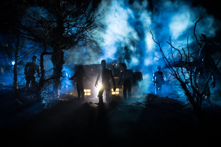 Silhouette of person standing in the dark forest with light. Horror halloween concept. strange silhouette in a dark spooky villageの写真素材