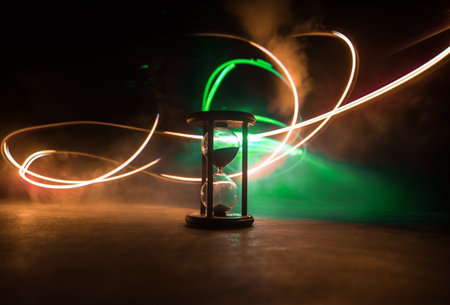 Hourglass as time passing concept for business deadline, urgency and running out of time. Sandglass,...