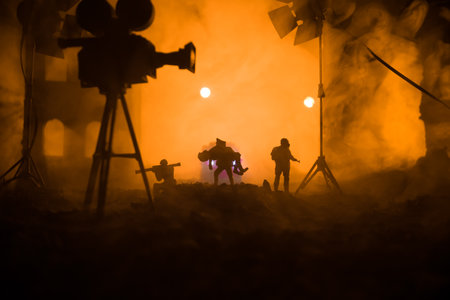 Action (War) movie concept. Man moving out with little boy from burned out city destroyed in war. Military fighting silhouettes. Selective focusの写真素材