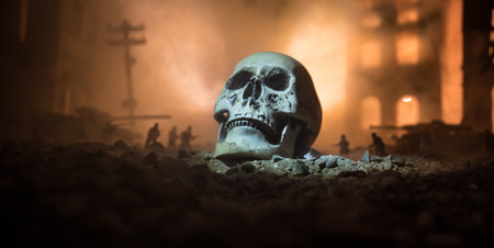 Concept of death soldiers during the war. Giant human skull with military fighting silhouettes in destroyed city. Selective focusの写真素材