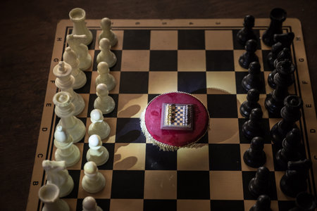 Chessboard with table miniature on chessboard. Chess board game concept of business ideas, competition and strategy. Chess playing chess concept. Selective focusの写真素材