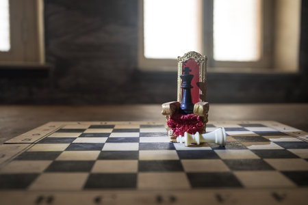 Red royal chair (Medieval Throne) miniature on chessboard. . Chess board game concept of business ideas and competition and strategy ideas concept. selective focusの写真素材