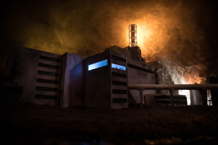 Creative artwork decoration. Chernobyl nuclear power plant at night. Layout of abandoned Chernobyl station after nuclear reactor explosion. Man silhouette in window. Selective focusの写真素材