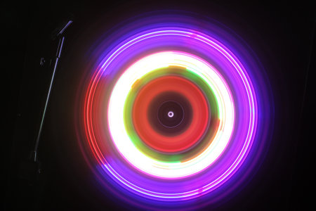 Music DJ concept. Trail of fire and smoke on vinyl record. Burning vinyl disk. Turntable vinyl record player on dark background. selective focusの写真素材