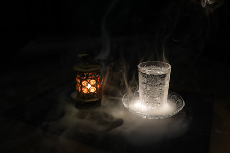 Suhoor or iftar time during Ramadan fasting. A glass of water to break the fast. Festive greeting...