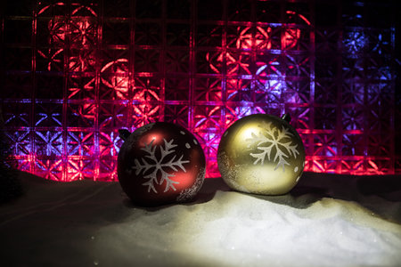 Christmas home decoration with snow and tree on a dark background with copy space. Cozy lights in...