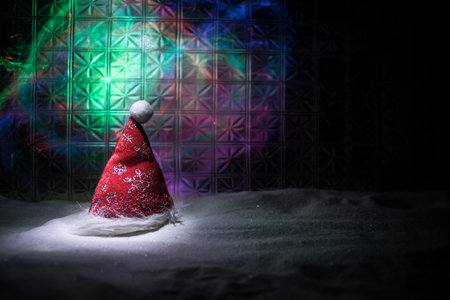 Christmas home decoration with snow and tree on a dark background with copy space. Cozy lights in selective focus. New Year attributes on backgroundの写真素材