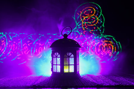 Ornamental Arabic lantern with burning candle glowing at night. Festive greeting card, invitation for Muslim holy month Ramadan Kareem(Eid Holiday) Dark background.の写真素材