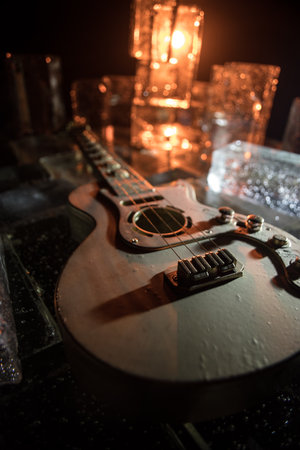 Guitar on a Dark Background with Vivid Light and Glass blocks decorの写真素材