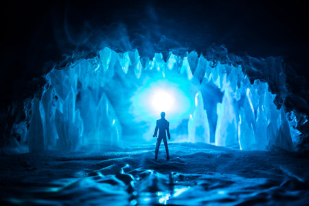 Majestic ice cave at night, illuminated by a magical glow, with mysterious silhouettes of people in a mystical and abstract atmosphere.の写真素材