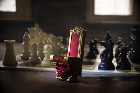 Red royal chair (Medieval Throne) miniature on chessboard. . Chess board game concept of business ideas and competition and strategy ideas concept. selective focusの写真素材