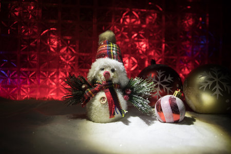 Christmas home decoration with snow and tree on a dark background with copy space. Cozy lights in selective focus. New Year attributes on backgroundの写真素材