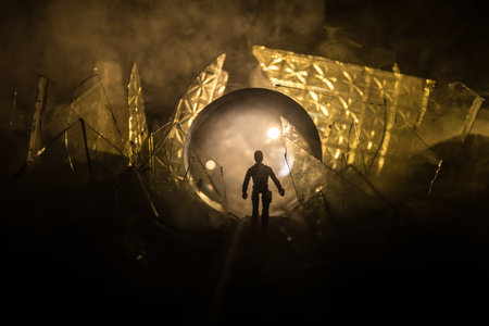 A silhouette of a person against the background of shattered glass. An abstract world made of glass shards. Surreal concept. Table top decoration. Selective focusの写真素材