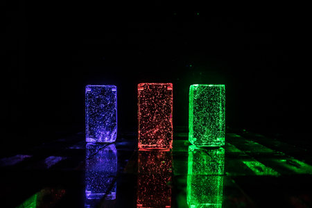 Colorful Glass Bricks Illuminated in Darkness: Vibrant Light Beams and Smoke Effects Creating a...
