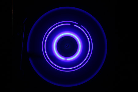 Music DJ concept. Trail of fire and smoke on vinyl record. Burning vinyl disk. Turntable vinyl record player on dark background. selective focusの写真素材