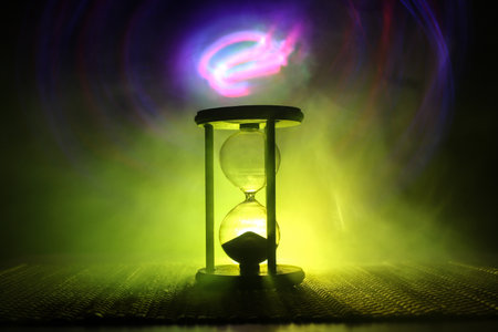 Hourglass as time passing concept for business deadline, urgency and running out of time. Sandglass,...