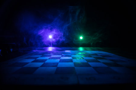 Chess board game concept of business ideas and competition. Chess figures on a dark background with...
