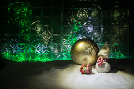 Christmas home decoration with snow and tree on a dark background with copy space. Cozy lights in...
