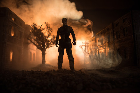 Artwork decoration. A man standing on a road of burnt up city. Apocalyptic view of city downtown as...