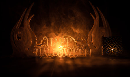 Halloween concept. Halloween pumpkin head in dark on table. Toned light with fog on background....