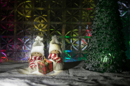 Christmas home decoration with snow and tree on a dark background with copy space. Cozy lights in selective focus. New Year attributes on backgroundの写真素材