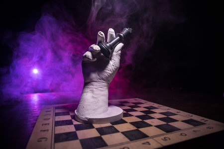 Chess board game concept of business ideas and competition. Chess figures on a dark background with smoke and fog. Selective focusの写真素材