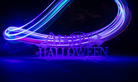 Halloween concept. Halloween pumpkin head in dark on table. Toned light with fog on background. Selective focus. Long shutter shotの写真素材