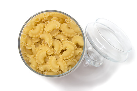 Italian pasta in a glass container with a lid on white background, top viewの写真素材