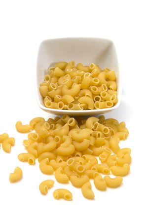 Italian pasta in a porcelain bowl on white background, top viewの写真素材