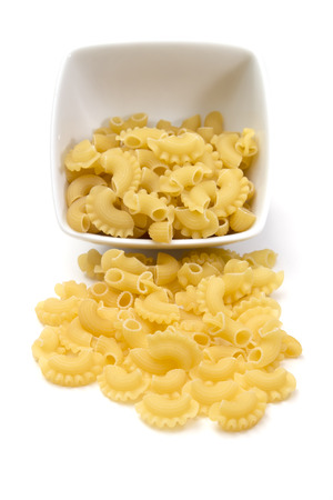 Italian pasta in a porcelain bowl on white background, top viewの写真素材