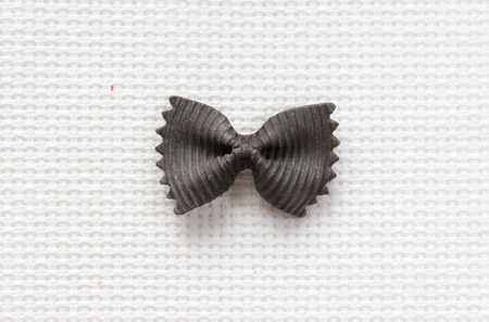 Italian bows black farfalle pasta from durum wheat on a white background, top viewの写真素材