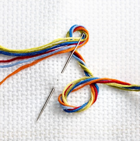 white cloth for embroidery anwhite cloth for embroidery and needle with colored thread floss, passion and work, hand work for peopled needle with colored thread floss, passion and work, hand work for peopleの写真素材