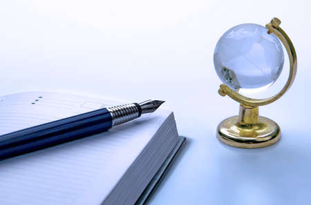 notebook and pen, globeの写真素材