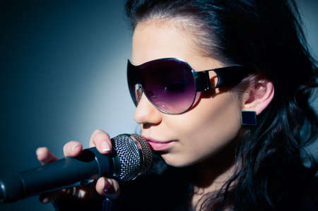 Girl Singing  Close-up of a young woman singing on stageの写真素材