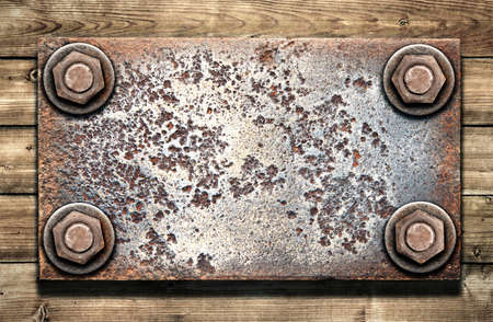 Old metal plate on  wooden wallの写真素材