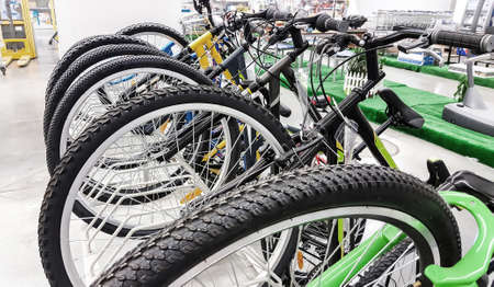 Row of bikes available to sell  in the shop.