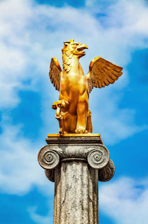 Griffin sculpture on pedestalの写真素材