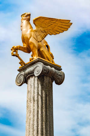 Griffin sculpture on pedestalの写真素材