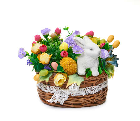 Easter basket from a flower arrangement and a hare on white background