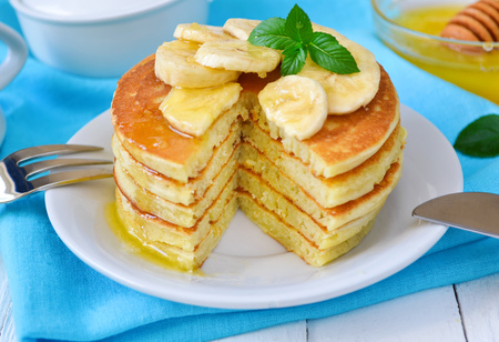 Pancake with banana, covered with honey or maple syrupの写真素材
