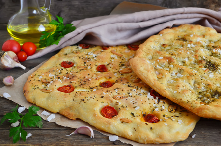 Focaccia with cherry tomatoes and Provencal herbsの写真素材