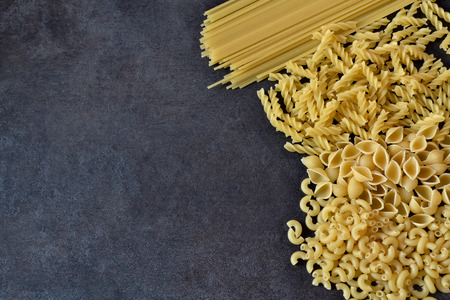 raw pasta on a dark backgroundの写真素材