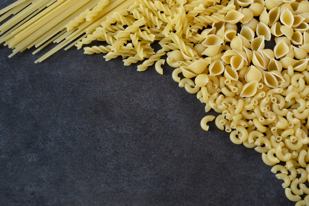 raw pasta on a dark backgroundの写真素材