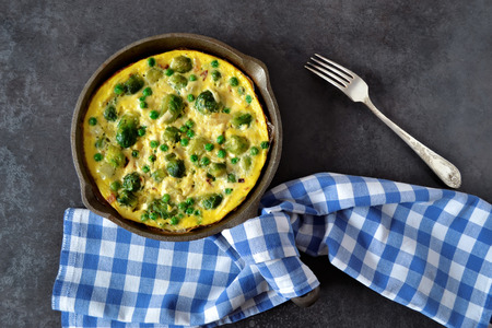 Frittata with cheese, green peas and Brussels sproutsの写真素材