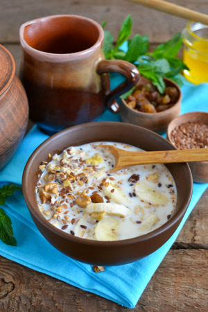 Granola with milk, walnuts and a banana for breakfastの写真素材