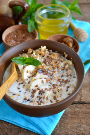 Granola with milk, walnuts and a banana for breakfastの写真素材