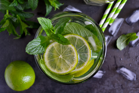 Mojito cocktail on black background with mint and limeの写真素材