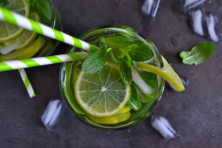 Mojito cocktail on black background with mint and limeの写真素材